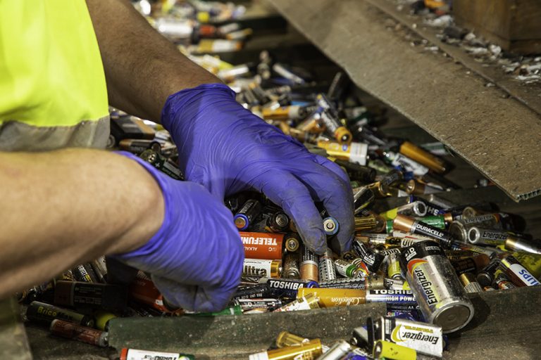 A worker sorting batteries